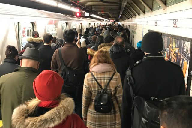 Commuters evacuate after being stranded on a downtown F train Monday morning